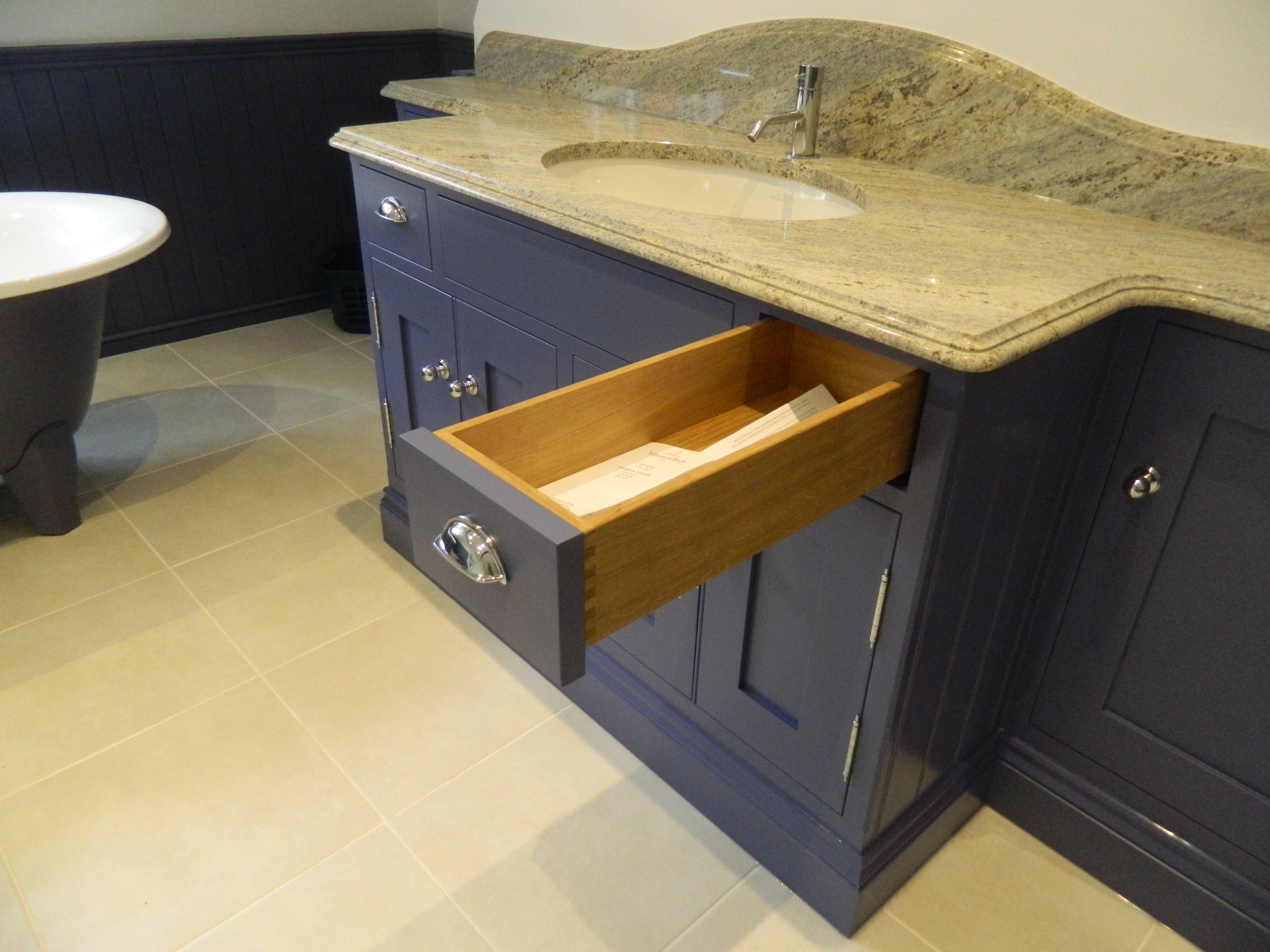 Bespoke vanity unit with dovetailed oak drawers and a granite top.